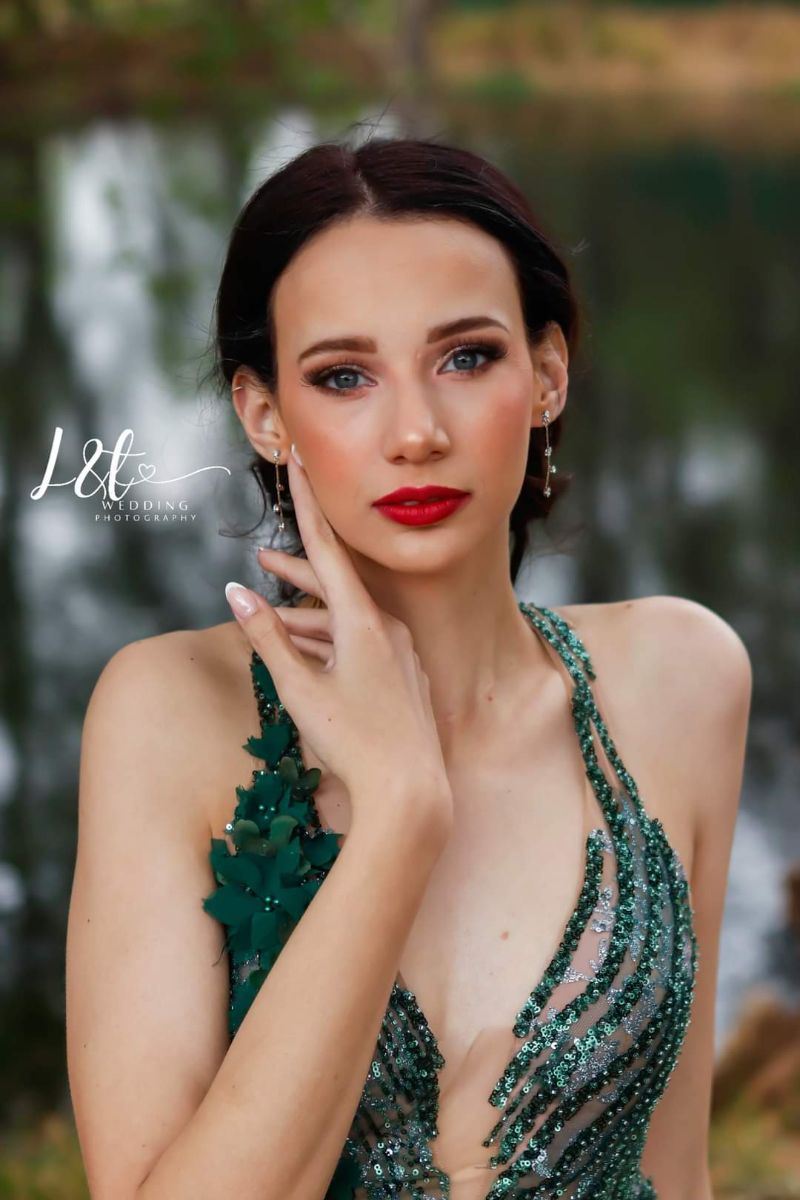 A person's eye adorned with subtle glitter on the eyelid, catching the light.